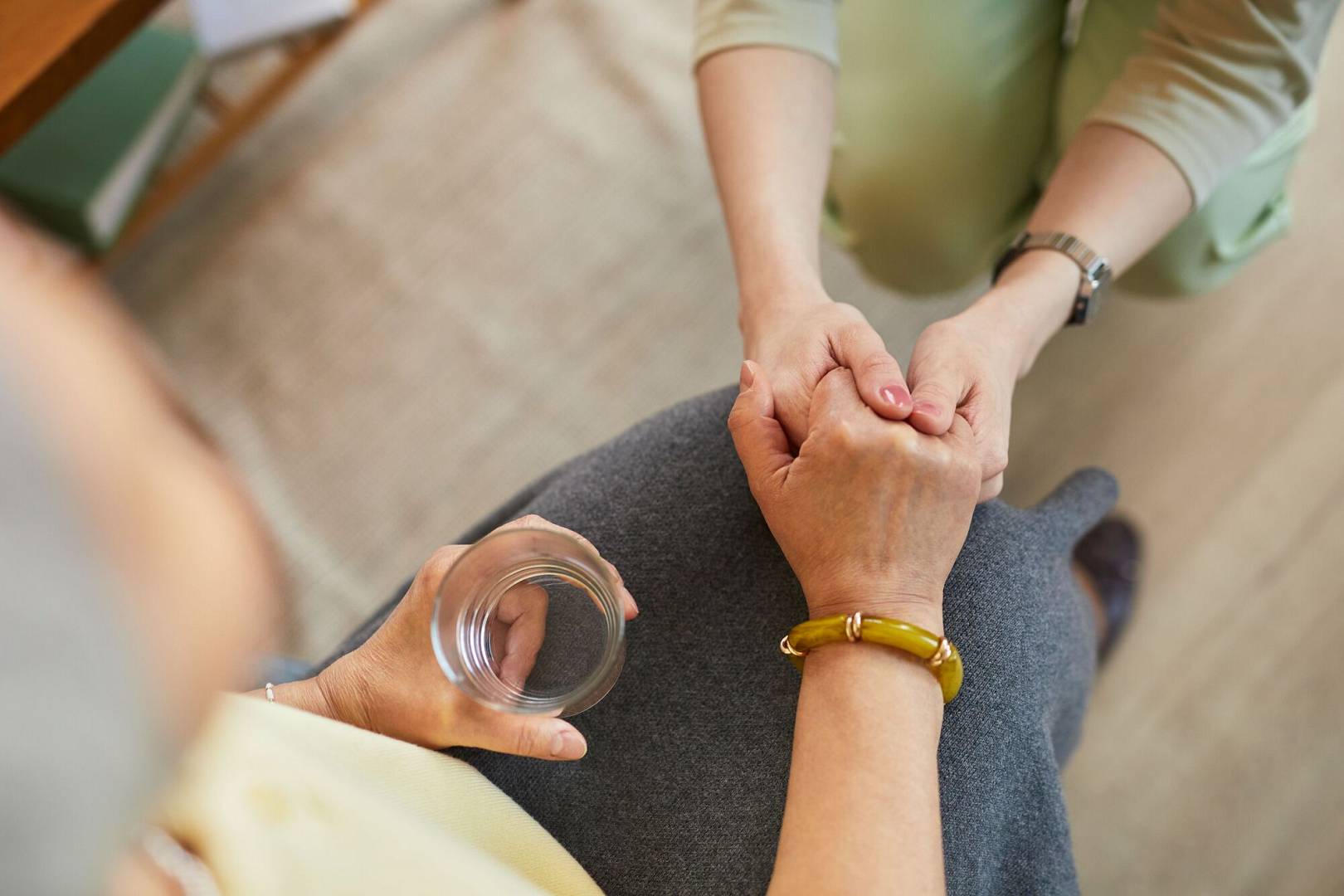 senior-woman-receiving-reassurance-from-caregiver-nursing-home.jpg